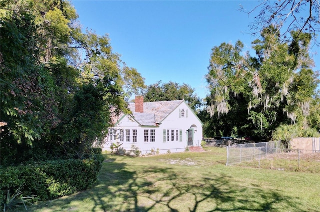 rear view of property with a yard