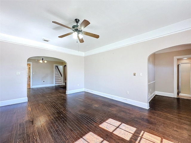 empty room with dark hardwood / wood-style floors and ceiling fan