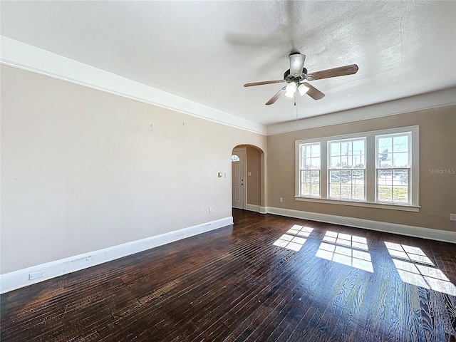 unfurnished room with a textured ceiling, ceiling fan, and dark wood-type flooring