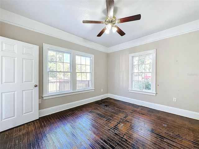 empty room featuring ceiling fan, dark hardwood / wood-style flooring, and ornamental molding