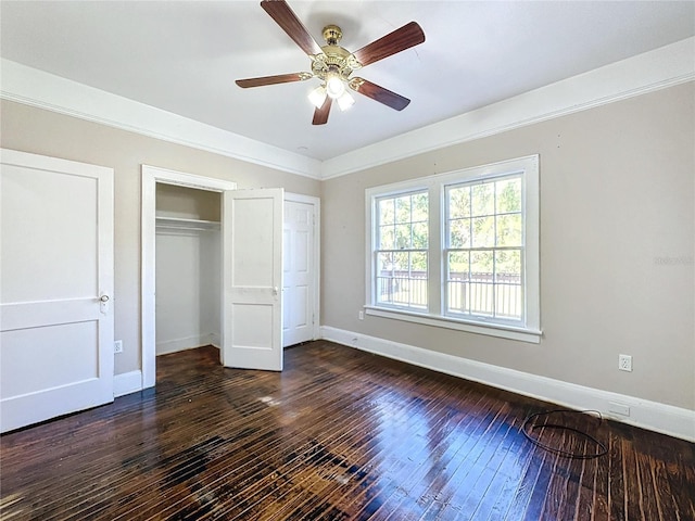 unfurnished bedroom featuring ceiling fan and dark hardwood / wood-style flooring