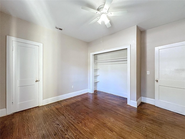 unfurnished bedroom featuring a closet, ceiling fan, and dark hardwood / wood-style flooring