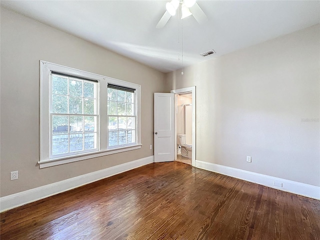 unfurnished bedroom featuring ceiling fan and dark hardwood / wood-style flooring