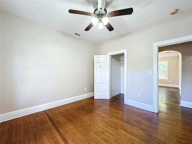 unfurnished bedroom with ceiling fan, dark hardwood / wood-style floors, and a closet