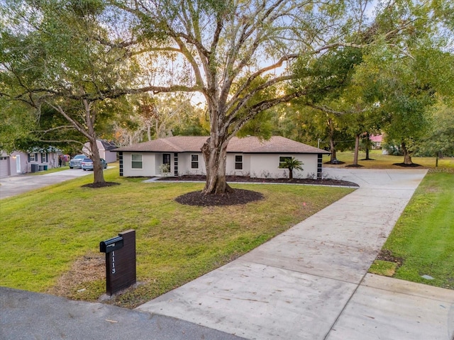 ranch-style home featuring a front yard