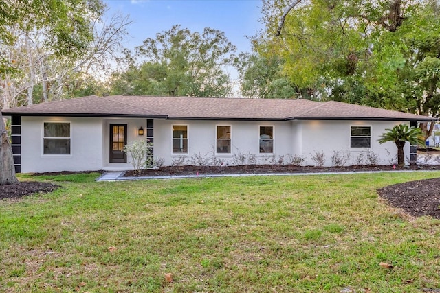 ranch-style home featuring a front lawn