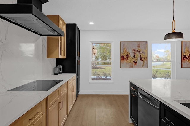 kitchen with black electric stovetop, light stone counters, stainless steel dishwasher, wall chimney range hood, and decorative light fixtures