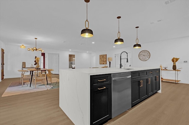 kitchen with dishwasher, a center island, hanging light fixtures, and sink