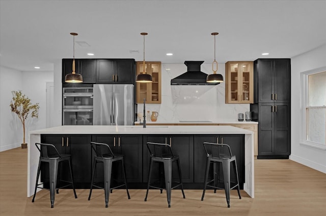 kitchen featuring pendant lighting, a large island, custom range hood, and stainless steel appliances