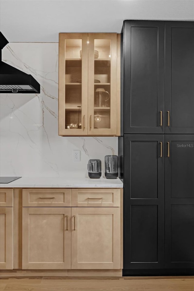 bar featuring ventilation hood, black electric cooktop, light stone counters, and light hardwood / wood-style floors