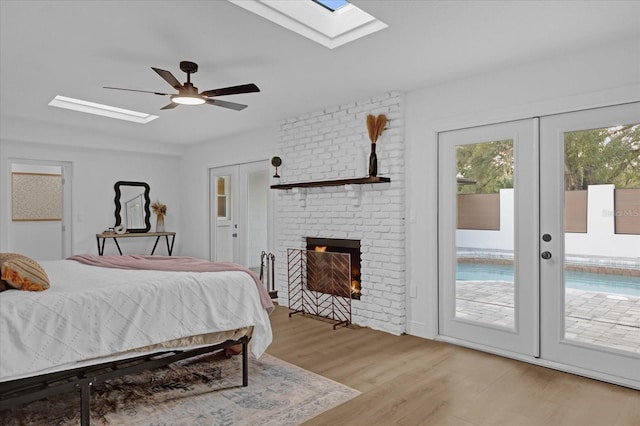 bedroom with ceiling fan, multiple windows, access to outside, and french doors