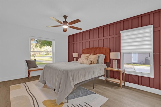 bedroom with ceiling fan and light hardwood / wood-style floors