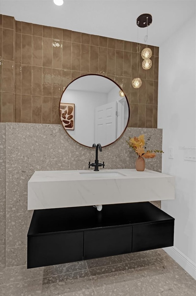 bathroom with vanity and tile walls