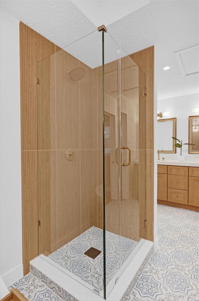 bathroom with tile patterned floors, vanity, and a shower with shower door