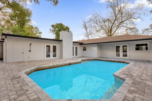 view of pool with a patio area and french doors