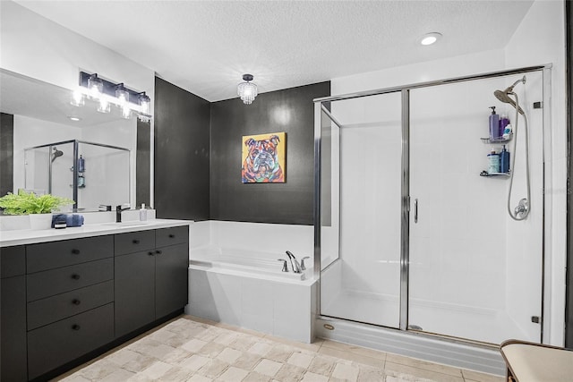 bathroom with plus walk in shower, vanity, and a textured ceiling