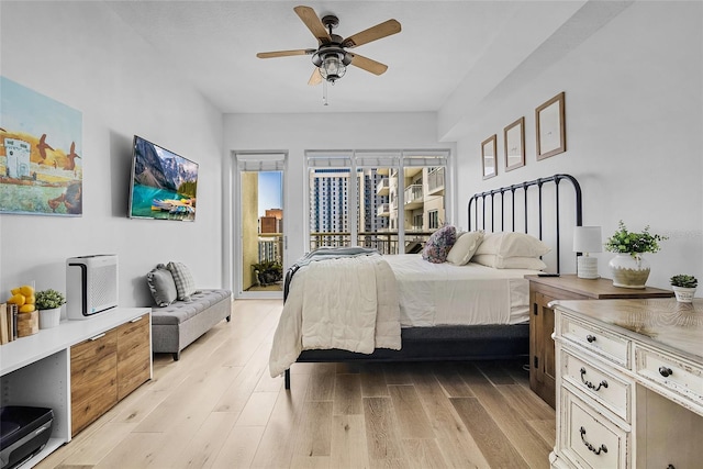 bedroom featuring light wood-type flooring, access to outside, and ceiling fan