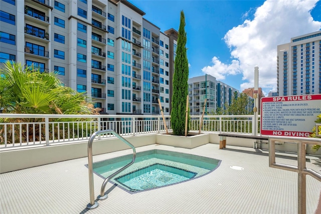 view of pool with a community hot tub