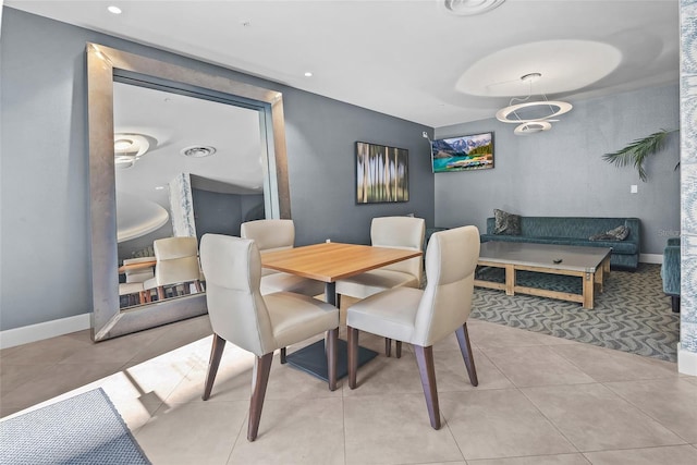 tiled dining area featuring a notable chandelier