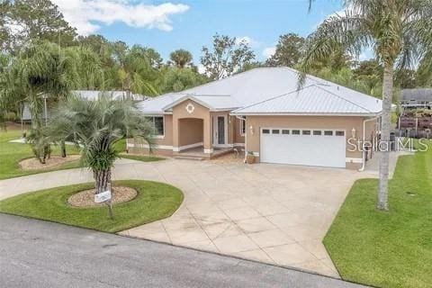 ranch-style house with a garage and a front lawn