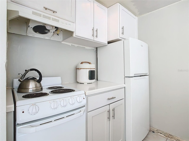 kitchen with white cabinetry and white appliances