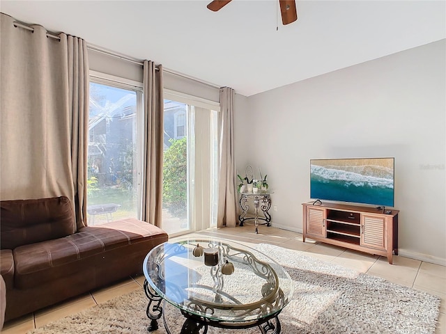 tiled living room with ceiling fan