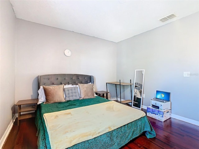 bedroom with dark wood-type flooring