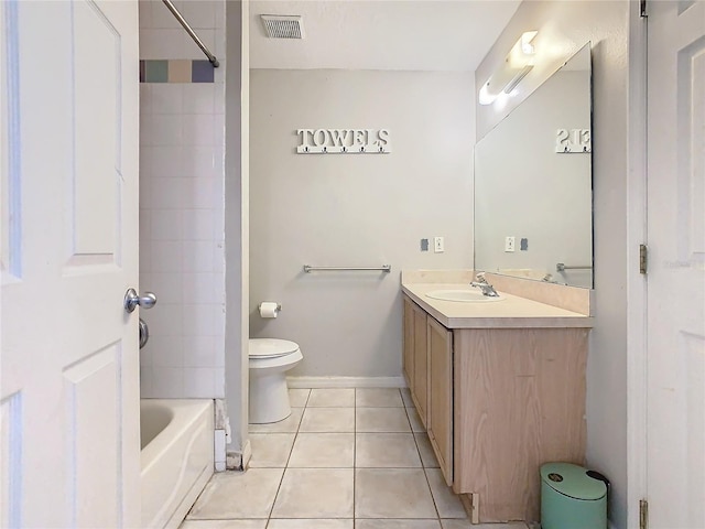 full bathroom featuring vanity, tiled shower / bath, tile patterned floors, and toilet