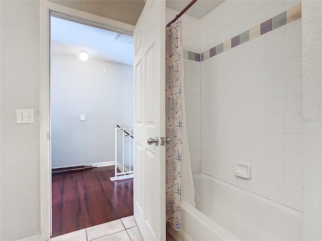 bathroom with tile patterned floors and shower / bath combo with shower curtain