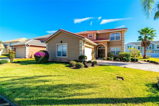 mediterranean / spanish-style house with a garage and a front yard