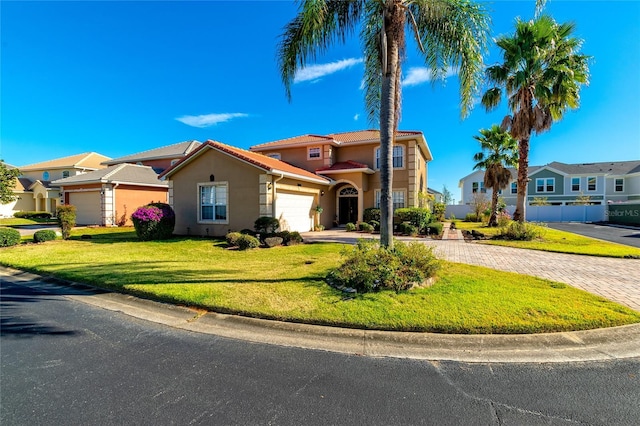 view of front facade with a garage and a front lawn