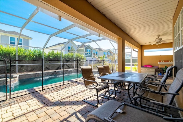 view of patio with pool water feature, a fenced in pool, ceiling fan, and a lanai