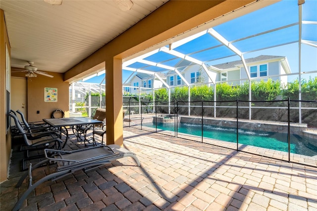 view of pool featuring a lanai, a patio area, and ceiling fan