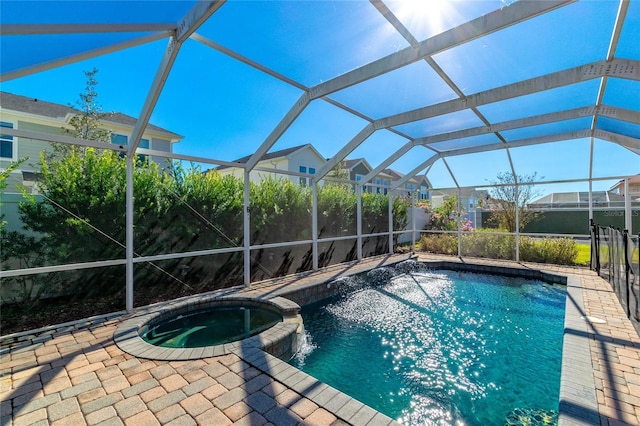 view of swimming pool featuring a lanai and an in ground hot tub