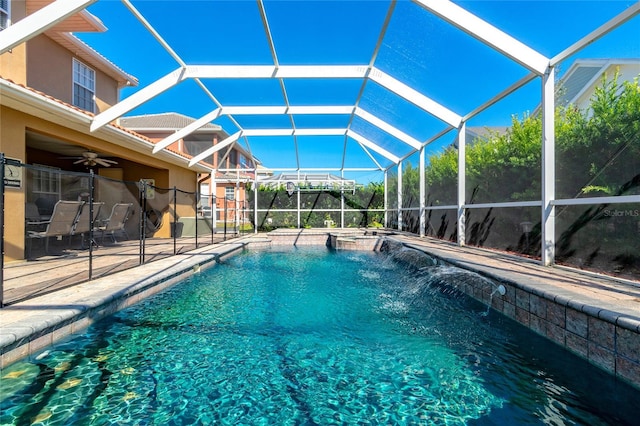 view of swimming pool featuring pool water feature, glass enclosure, and a patio