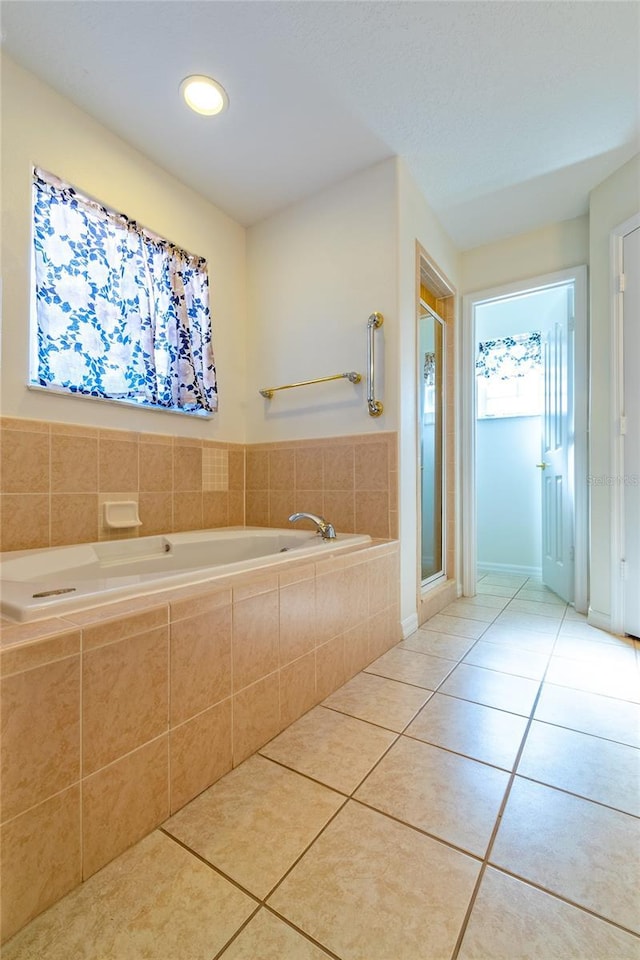 bathroom featuring tile patterned floors and shower with separate bathtub