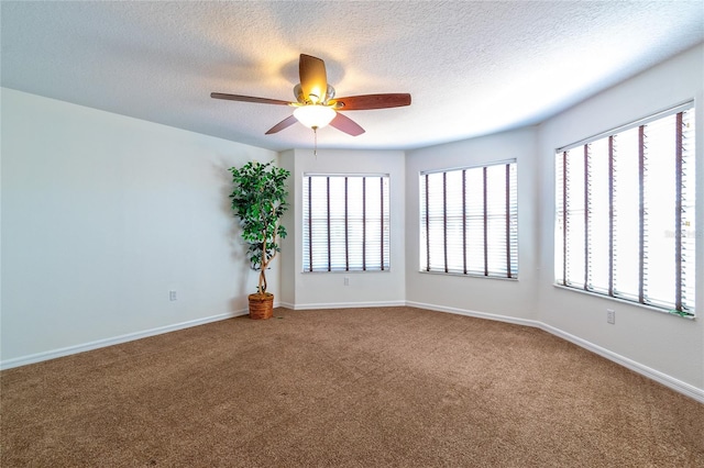 spare room with ceiling fan, carpet floors, and a textured ceiling