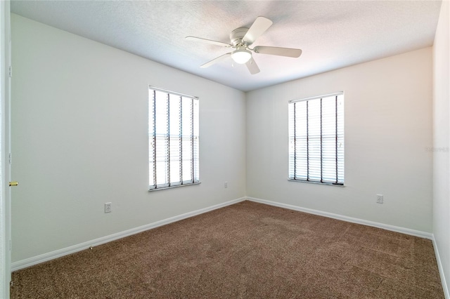 empty room featuring carpet, ceiling fan, and a textured ceiling