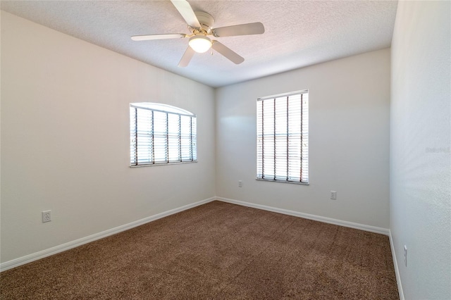 carpeted empty room with a textured ceiling and ceiling fan