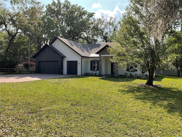 view of front of property featuring an attached garage, driveway, a front yard, and board and batten siding