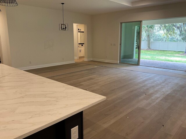 interior space featuring baseboards and wood finished floors