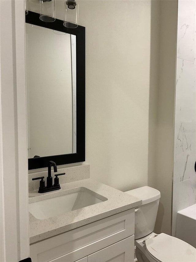 bathroom with toilet and vanity