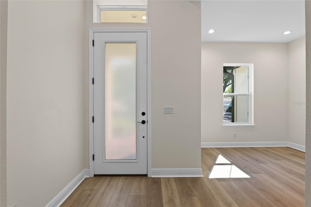 entrance foyer featuring light wood-style flooring, baseboards, and recessed lighting