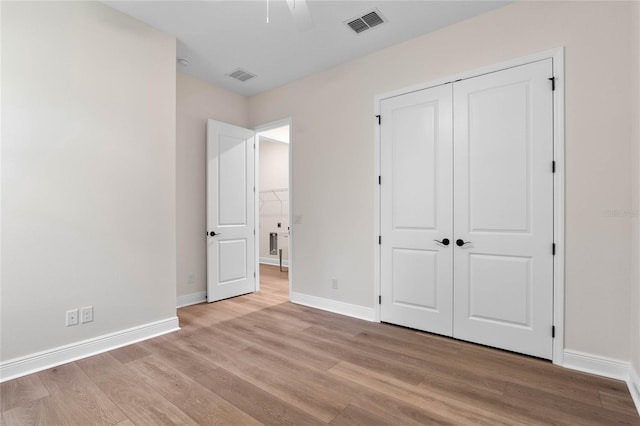 unfurnished bedroom featuring visible vents, baseboards, and light wood-style floors