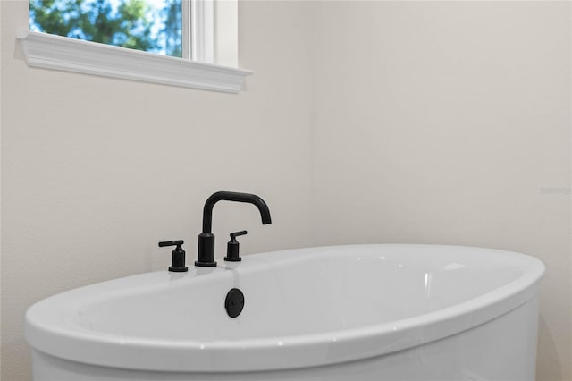 full bath with a freestanding bath and a sink