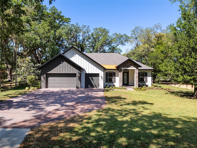 modern inspired farmhouse featuring board and batten siding, aphalt driveway, a garage, and a front lawn