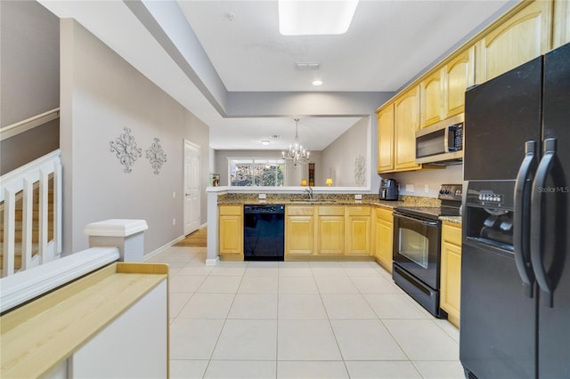 kitchen featuring kitchen peninsula, sink, black appliances, decorative light fixtures, and a chandelier