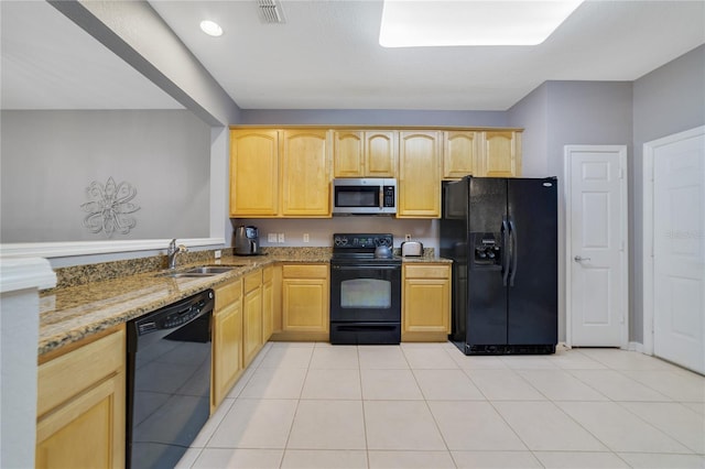 kitchen featuring light stone counters, sink, black appliances, light brown cabinets, and light tile patterned floors