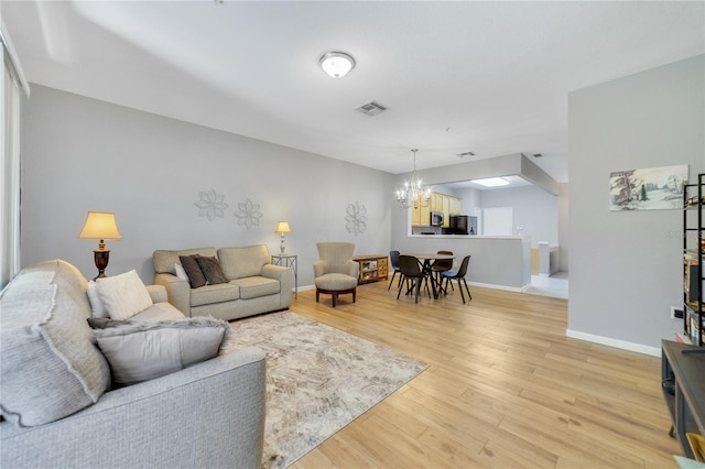 living room featuring hardwood / wood-style floors and a notable chandelier