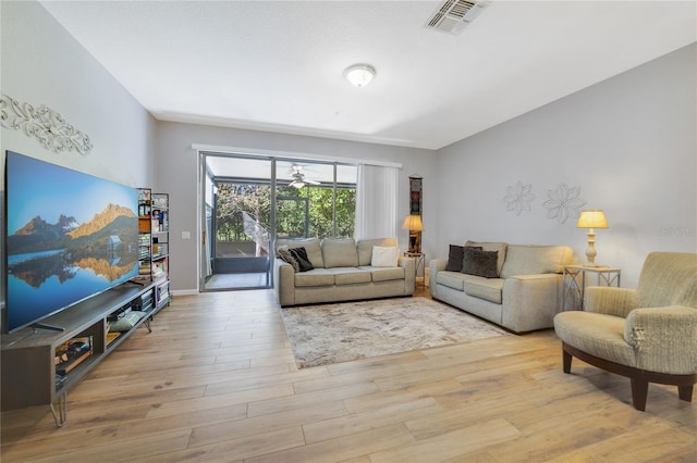 living room featuring ceiling fan and light hardwood / wood-style floors